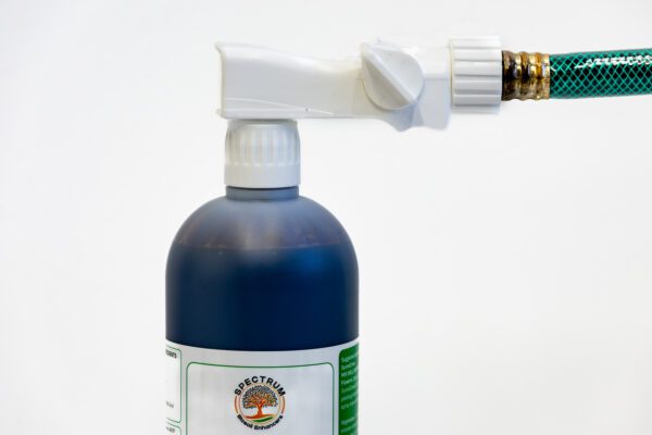 A bottle of liquid with a spray nozzle attached to it.